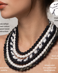 Sassy Jones Kenza necklace featuring cascading black, white and patterned fabric wrapped bead strands.
