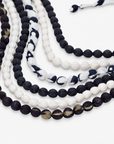 Black and white statement bib necklace with layered cloth beads and coordinating fabric tie closure.