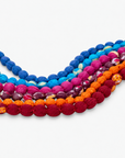 Multicolor statement bib necklace with orange, berry, blue, turquoise and magenta cloth beads.