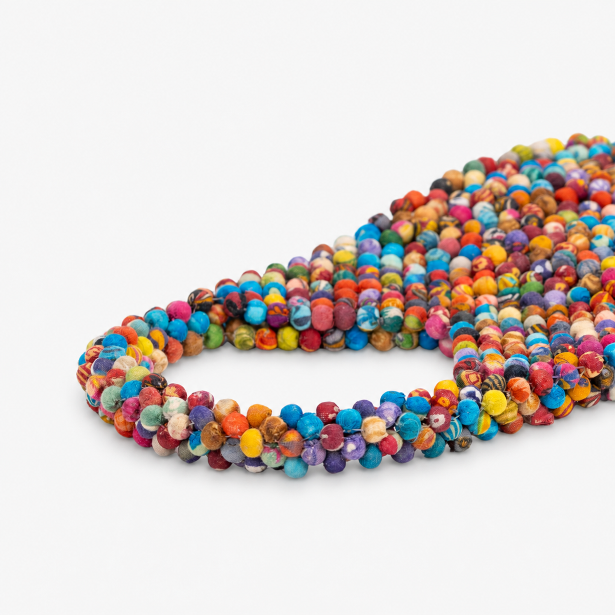 1. Kenza multicolor beaded tote featuring mixed solid and patterned fabric wrapped beads from handle to base.