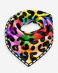A square scarf with a vibrant rainbow watercolor splatter background and black leopard spots, finished with a white dashed border, shown on a light gray background.