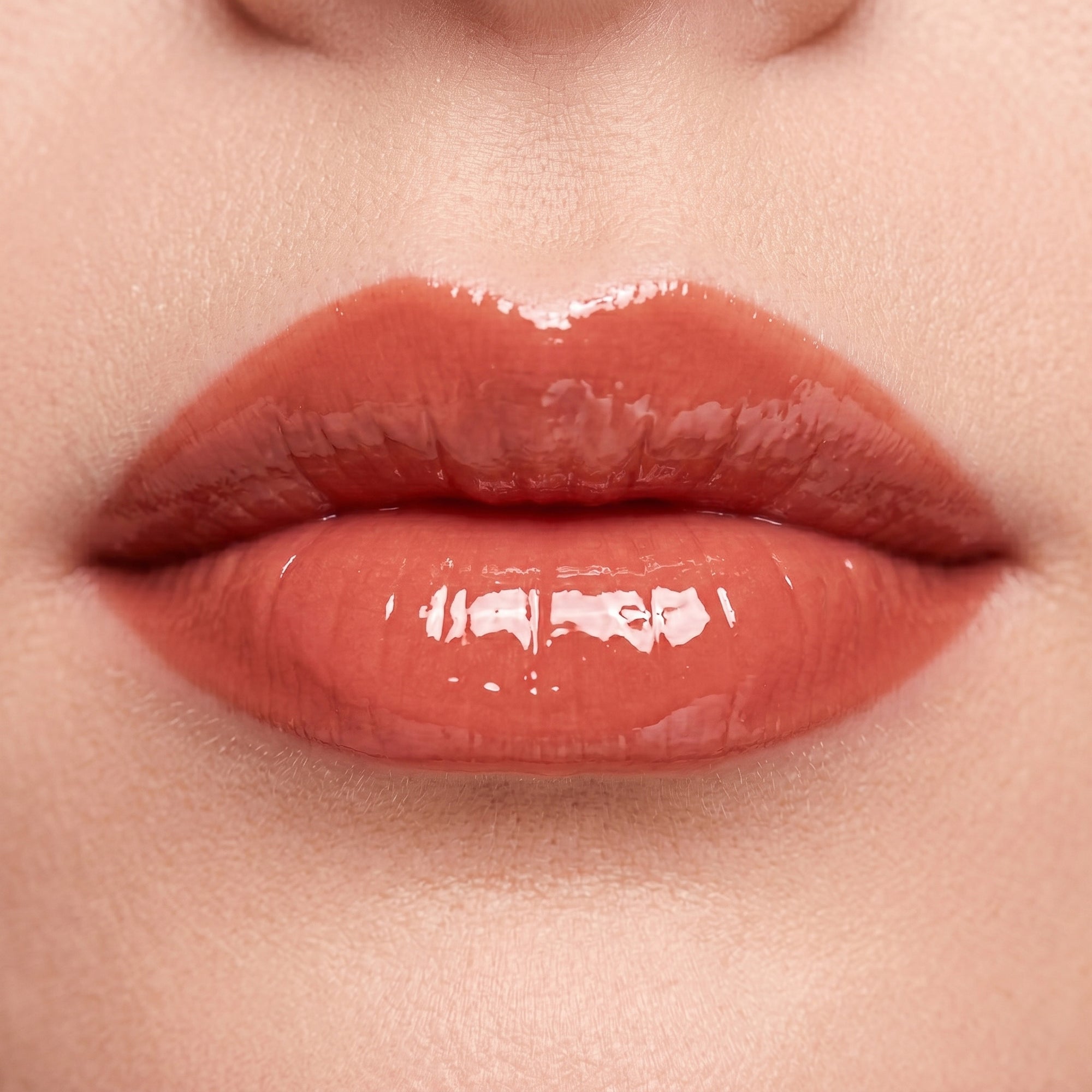 Soft Life Lip Butter gloss in a vibrant coral red shade with high shine finish and smooth creamy texture