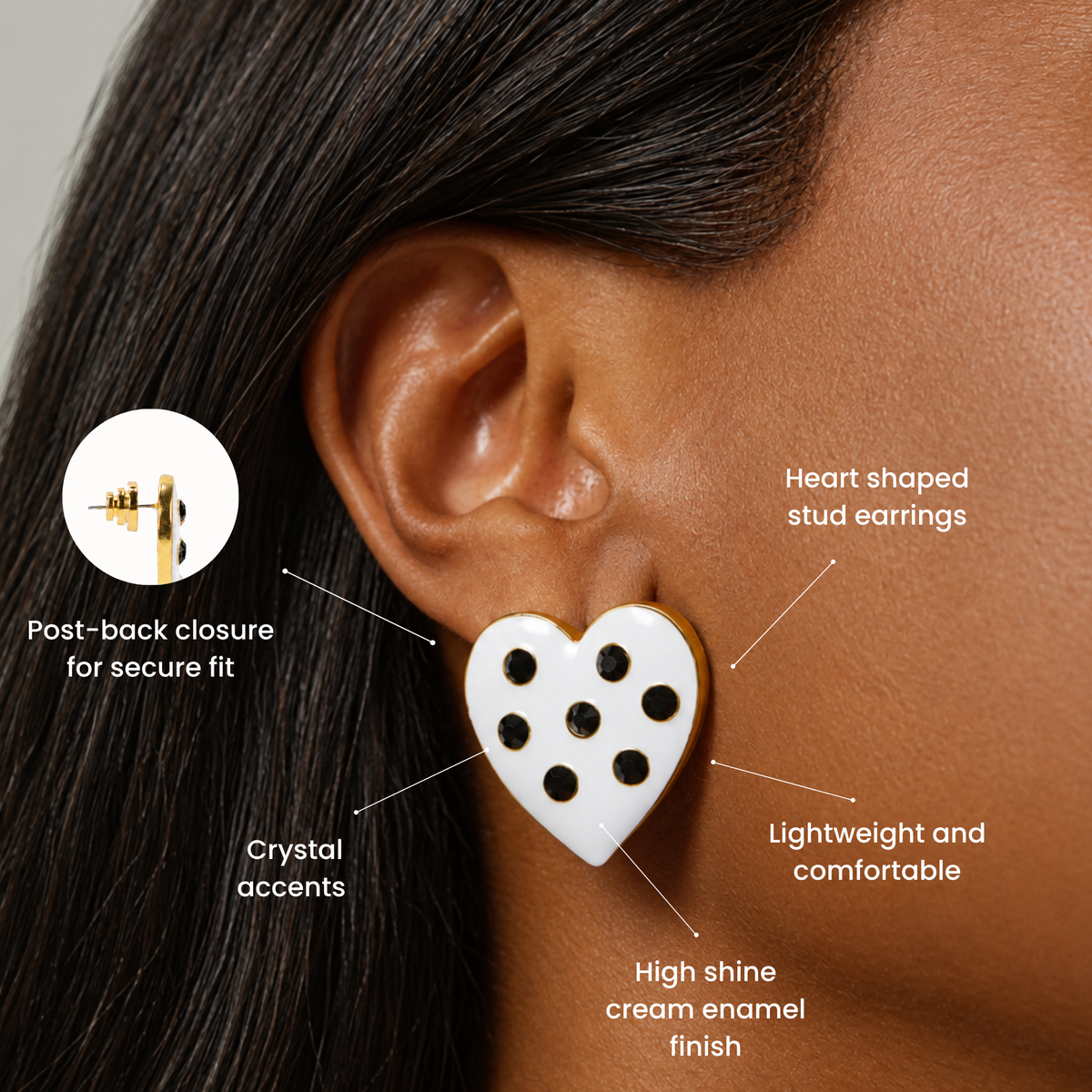 White heart stud earrings decorated with seven black crystals and delicate gold detailing.