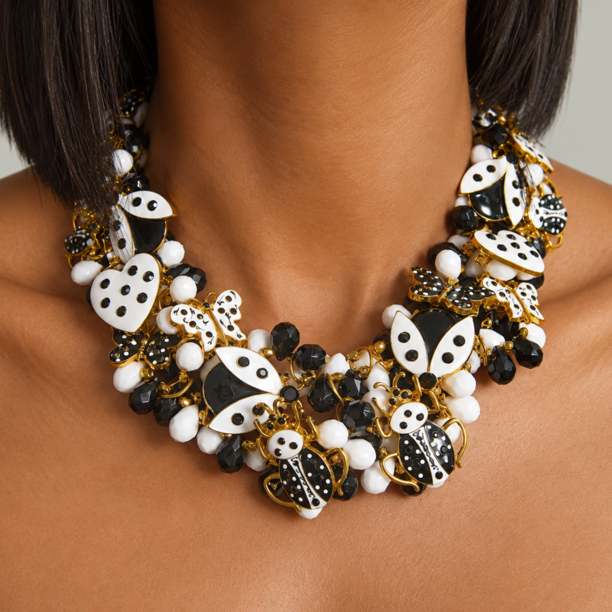 Lovebug Black and White statement necklace featuring spotted hearts, butterflies, ladybugs and layered beadwork.