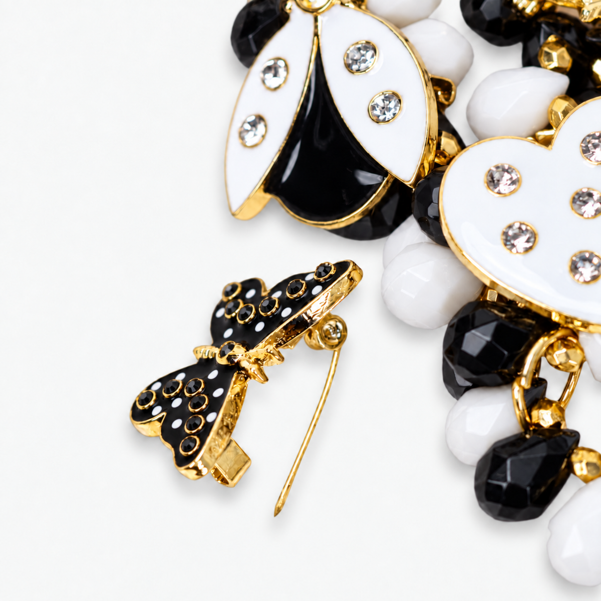 Lovebug 18K Brooch Bib - Black/White featuring layered black and white beads with removable heart, butterfly and ladybug motifs.