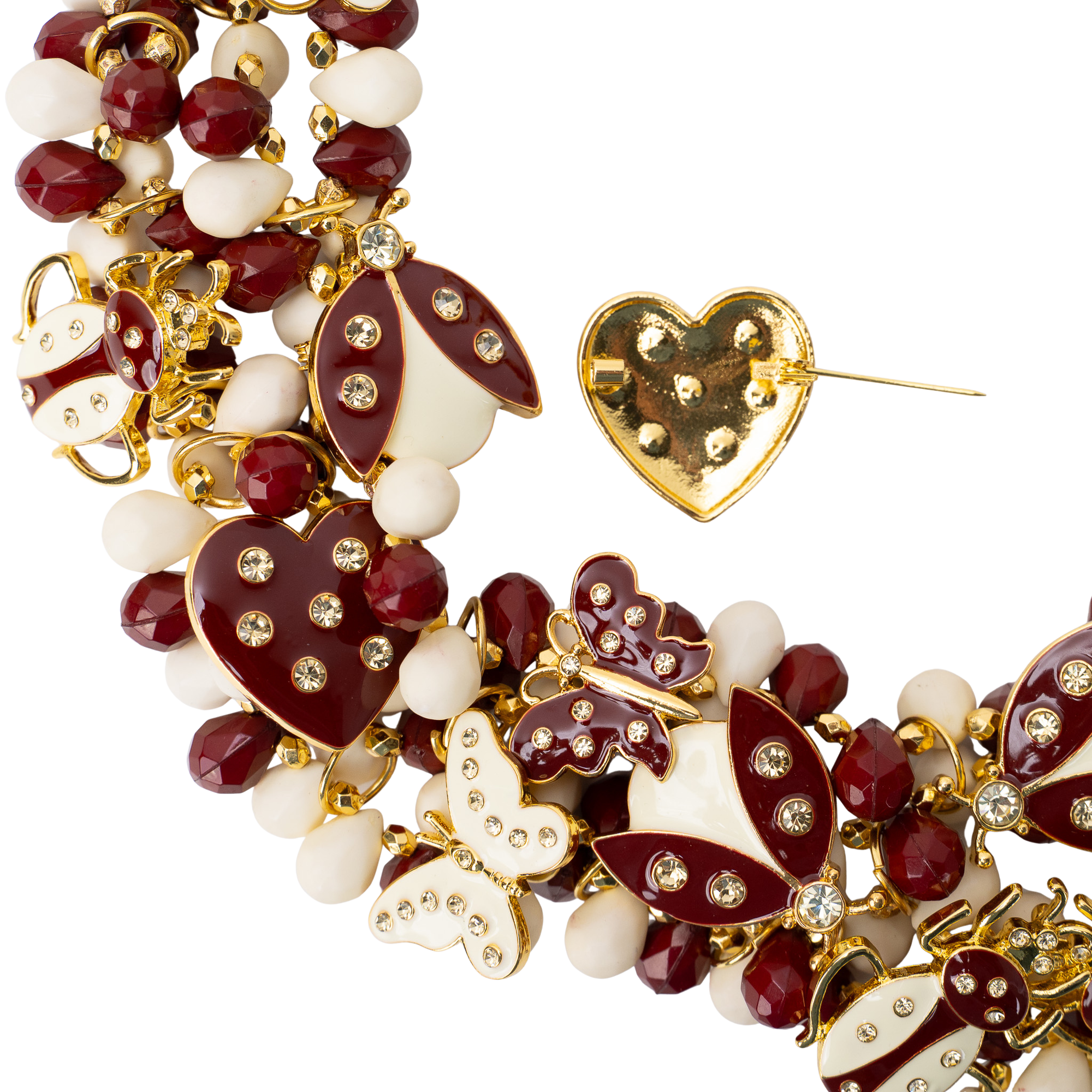 Crimson and cream statement bib necklace featuring removable butterfly, ladybug, and heart brooch charms with 18K gold-plated accents and faceted bead details.