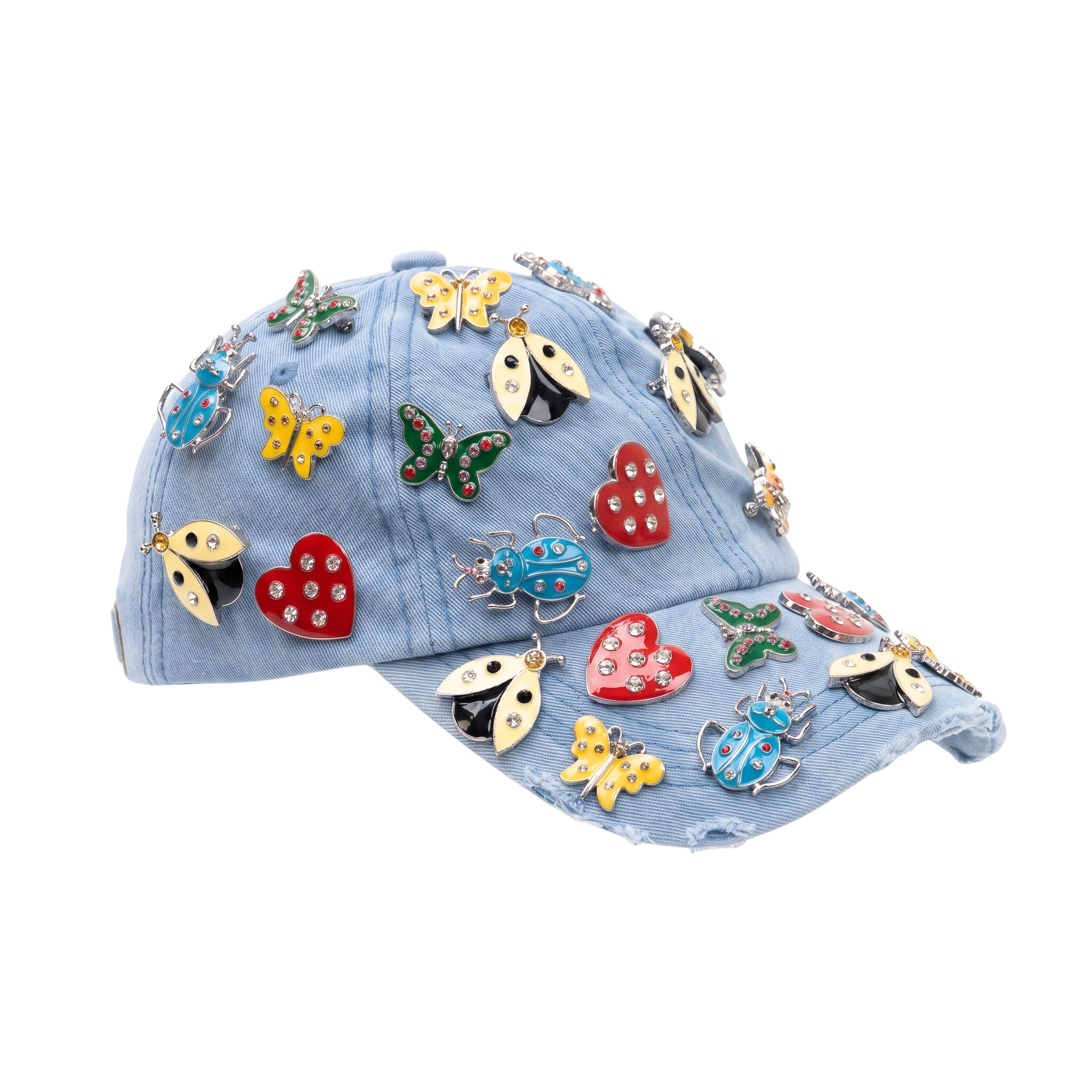 Light wash distressed denim ballcap featuring removable butterfly, ladybug, heart, and floral crystal brooch pins by Sassy Jones.