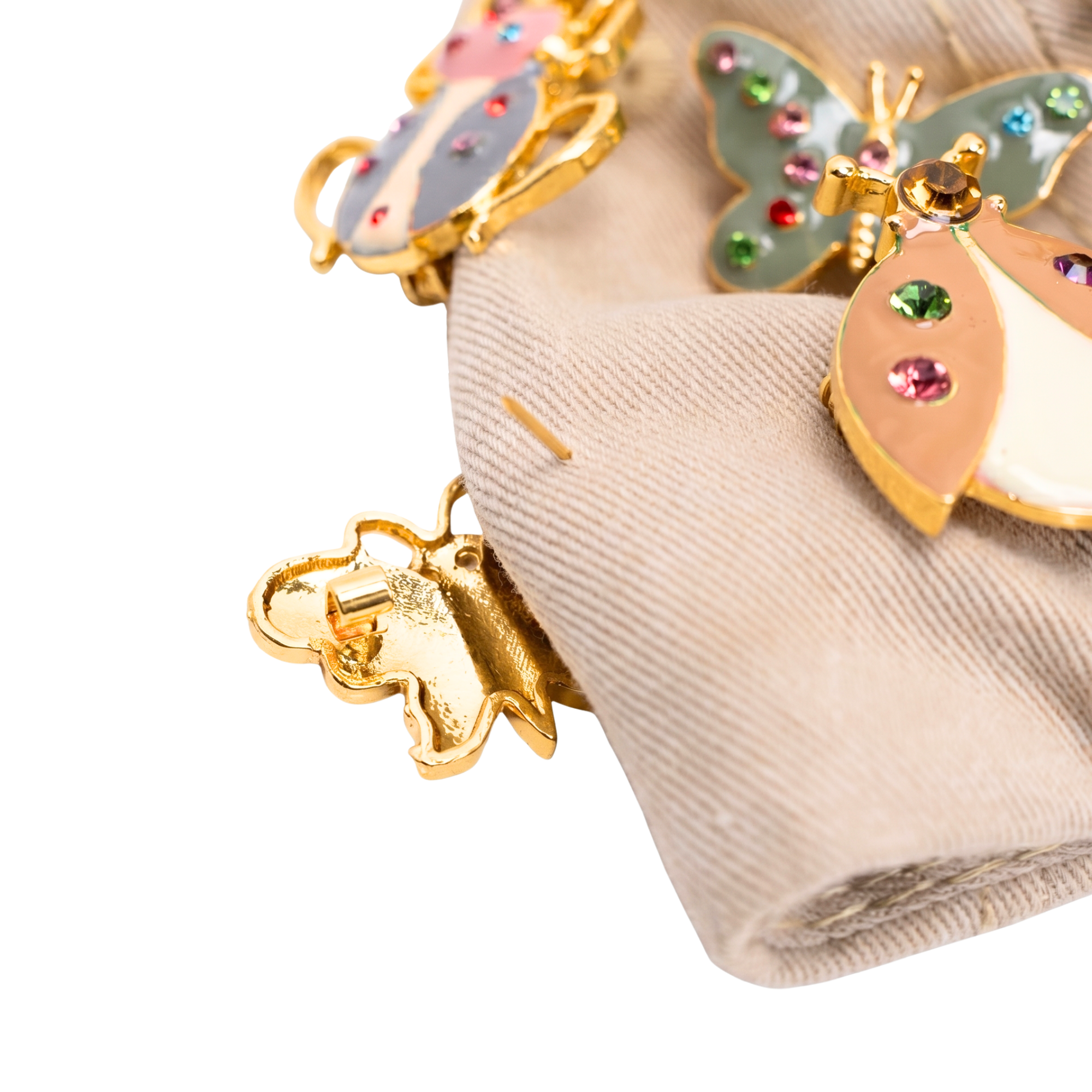 Tan distressed denim ballcap featuring removable butterfly, ladybug, heart, and floral crystal brooch pins by Sassy Jones.