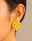 Close up of Lovebug 18K Carnivale Stud featuring seven colorful crystals across a glossy yellow heart.