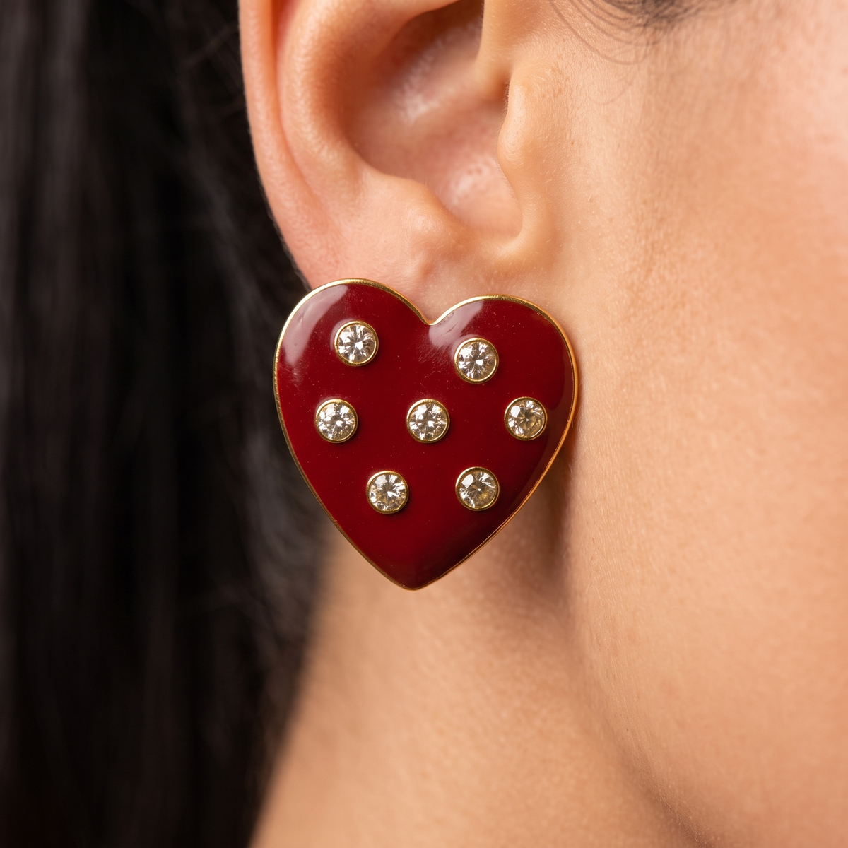 Crimson heart statement earrings featuring scattered round crystals and a polished 18K gold plated border.