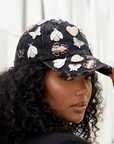 Black distressed denim ballcap featuring removable butterfly, ladybug, heart, and floral crystal brooch pins by Sassy Jones.