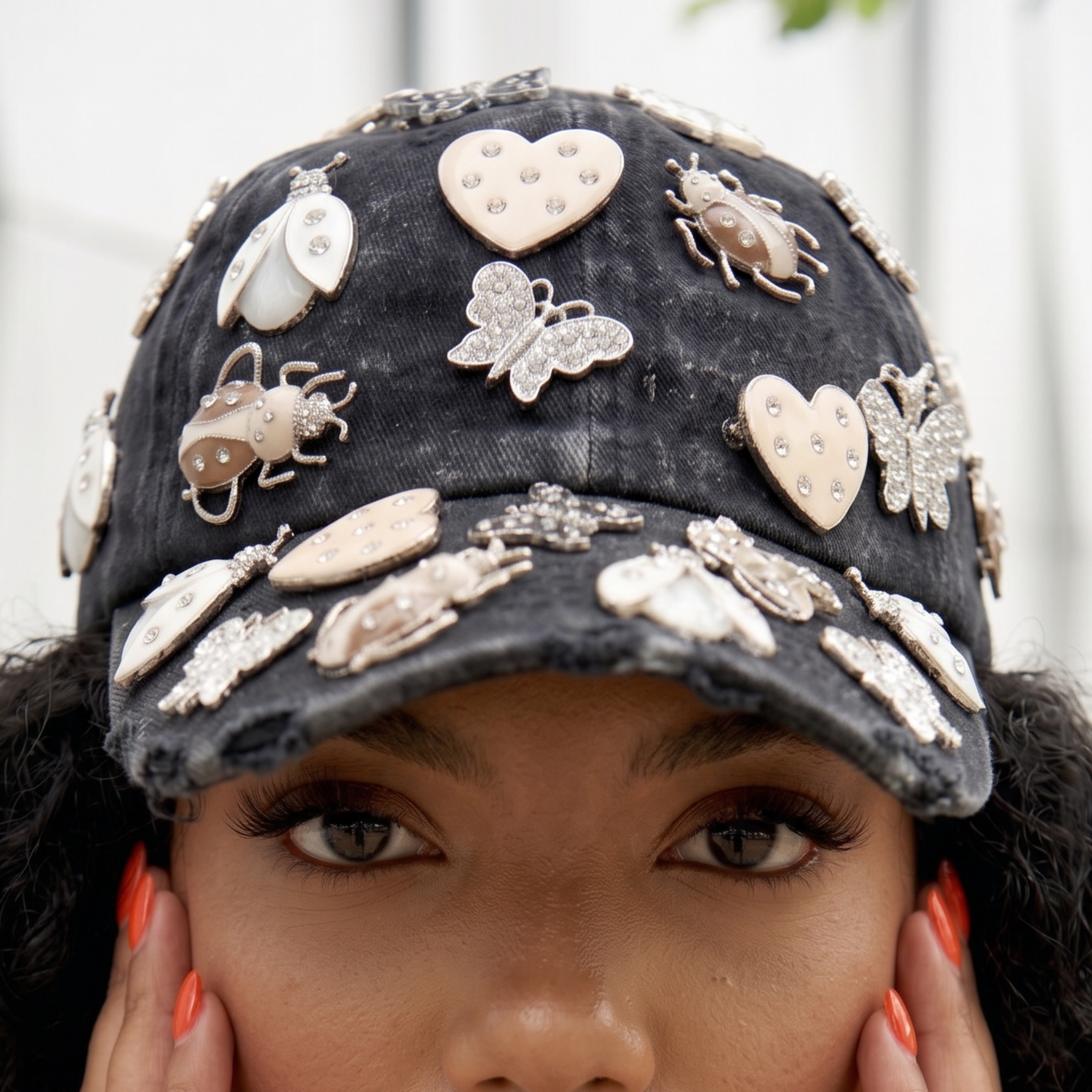 Black distressed denim ballcap featuring removable butterfly, ladybug, heart, and floral crystal brooch pins by Sassy Jones.