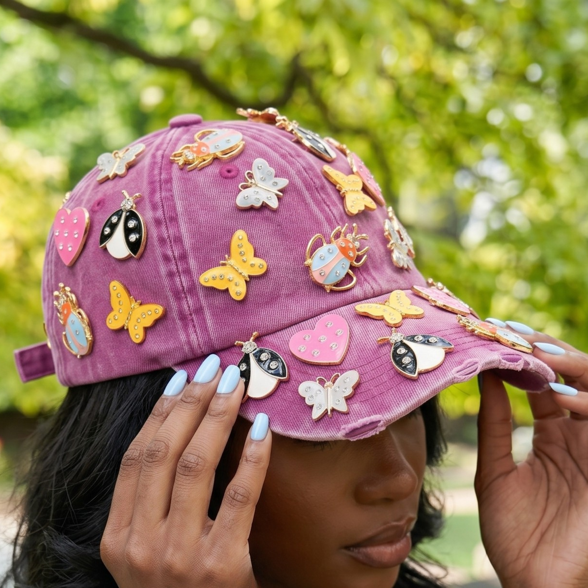 Pink distressed denim ballcap featuring removable butterfly, ladybug, heart, and floral crystal brooch pins by Sassy Jones.