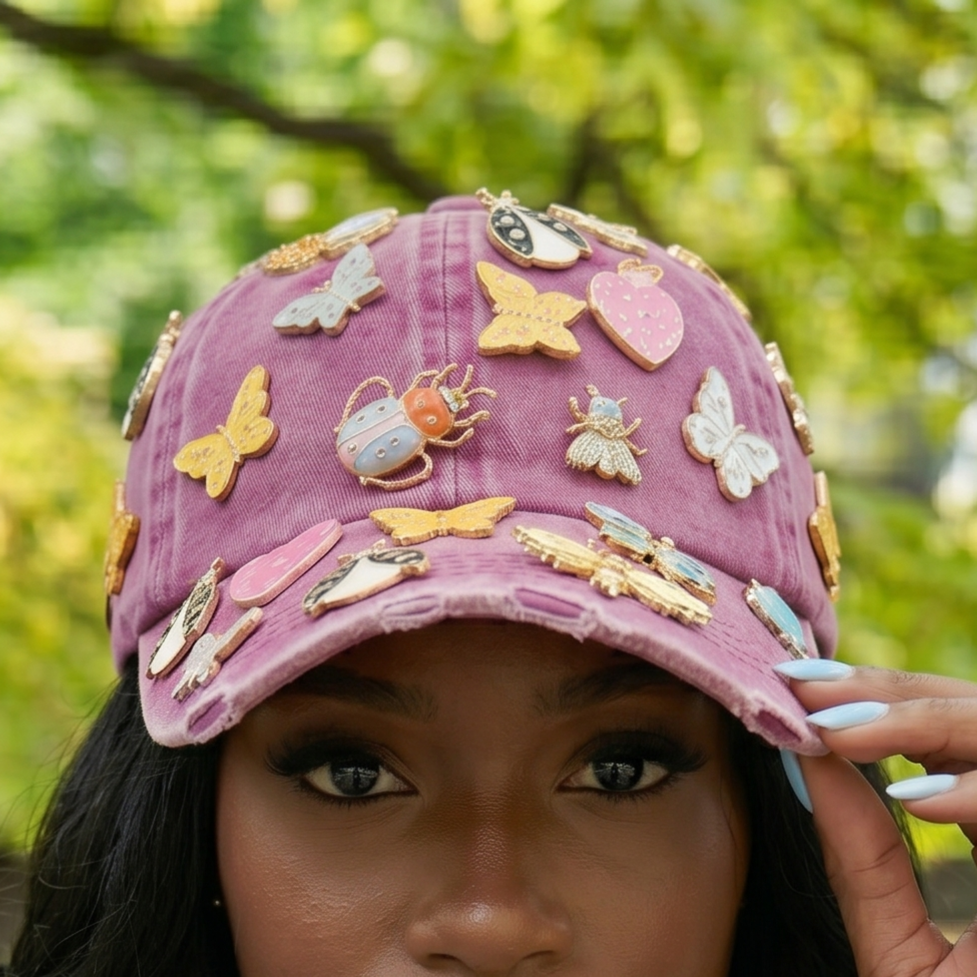 Pink distressed denim ballcap featuring removable butterfly, ladybug, heart, and floral crystal brooch pins by Sassy Jones.