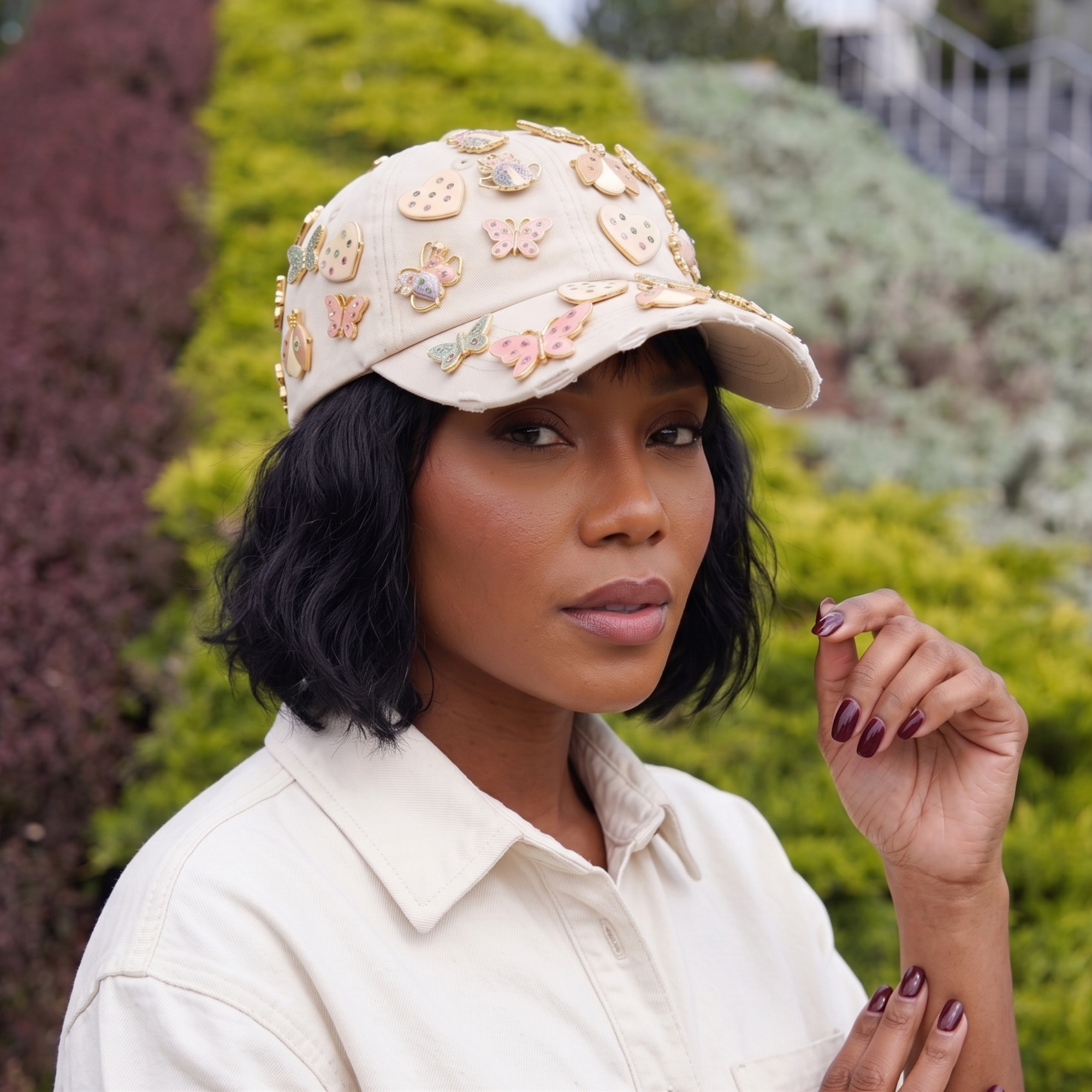 Tan distressed denim ballcap featuring removable butterfly, ladybug, heart, and floral crystal brooch pins by Sassy Jones.