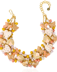 Peach and cream statement bib necklace featuring removable butterfly, ladybug, and heart brooch charms with 18K gold-plated accents and faceted bead details.
