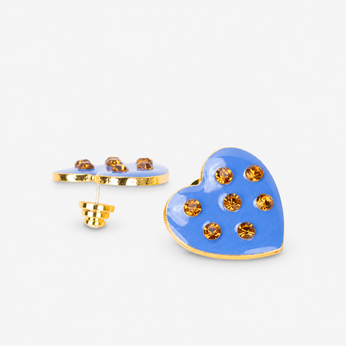 On model view of Lovebug Paradise Blue heart stud earring with warm golden crystals and polished gold edging.