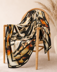 Close up of Mary Butler Leopard Abstract Scarf highlighting fluid black shapes, leopard spots and warm neutral tones.