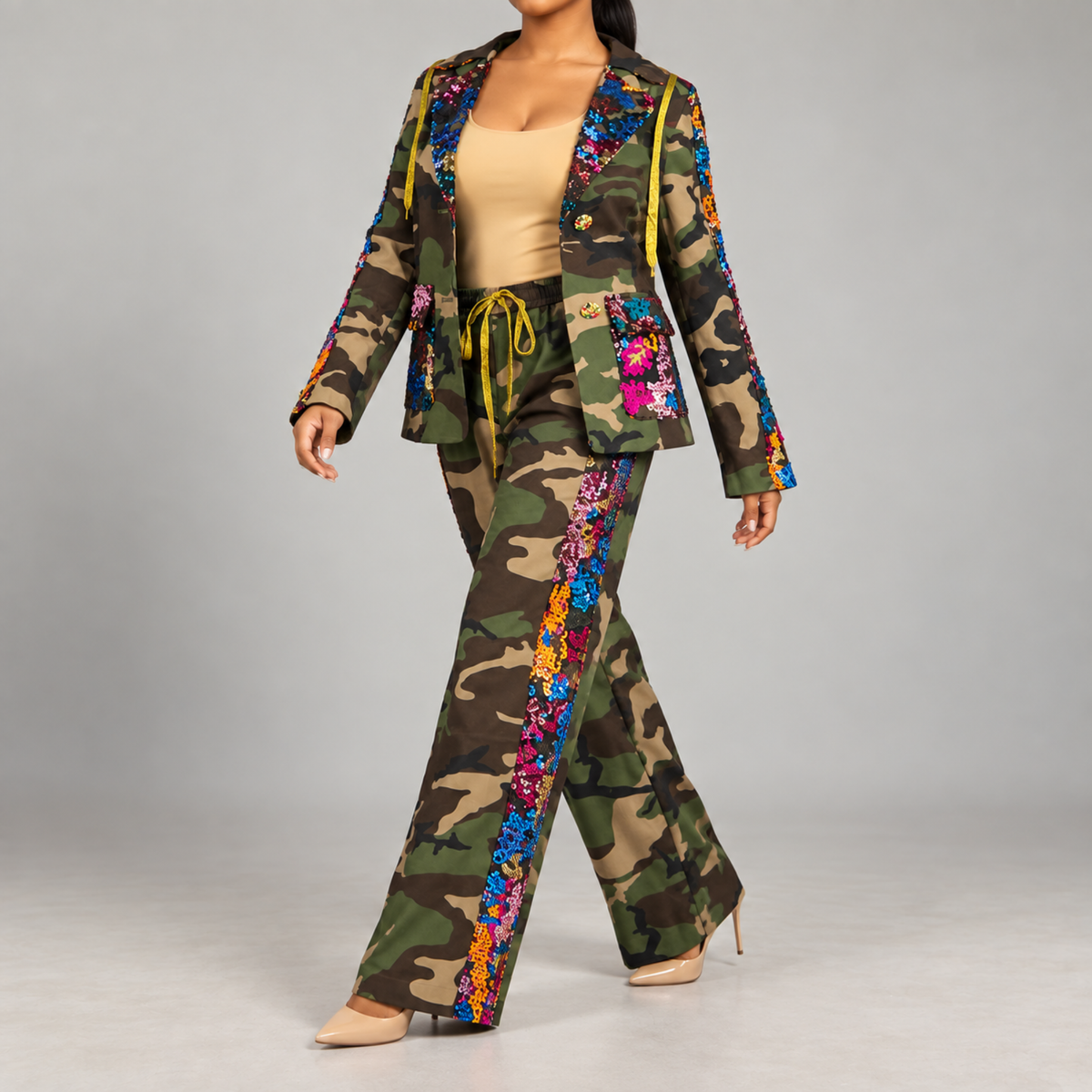 Women's statement camo pants featuring functional pockets, wide legs and multicolor sequin embellishment.