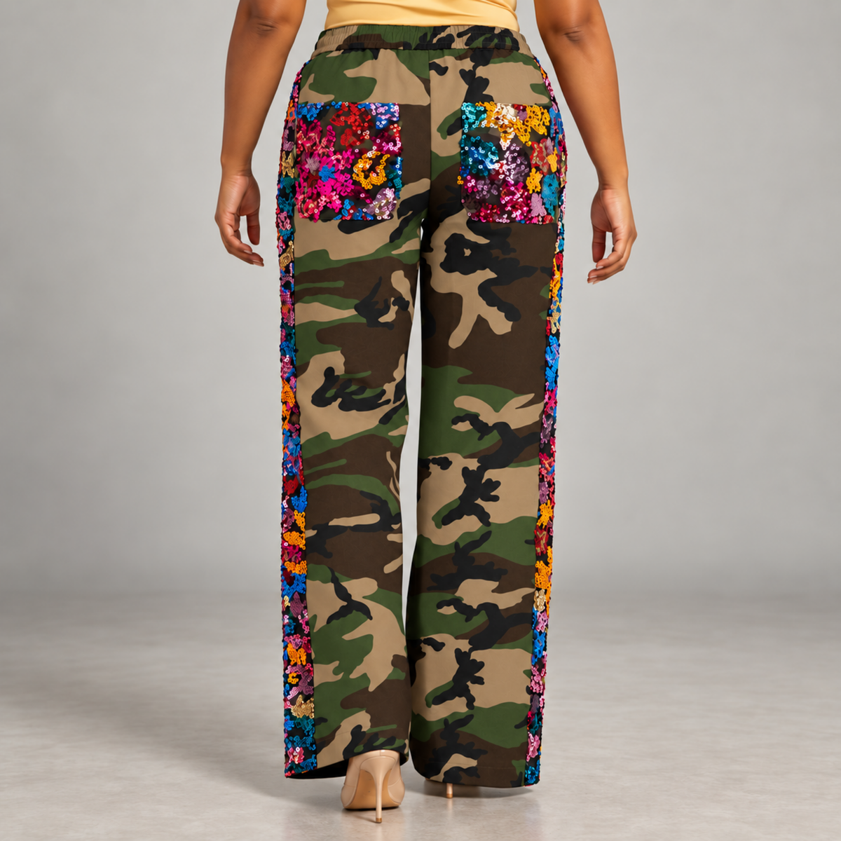 Women's wide leg camouflage track pants with vibrant blue, pink, red and orange sequin detailing.