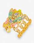 Close up of Miss Beasley Cuff showing faceted multicolor stones, colorful enamel details and elaborate gold scrollwork. 