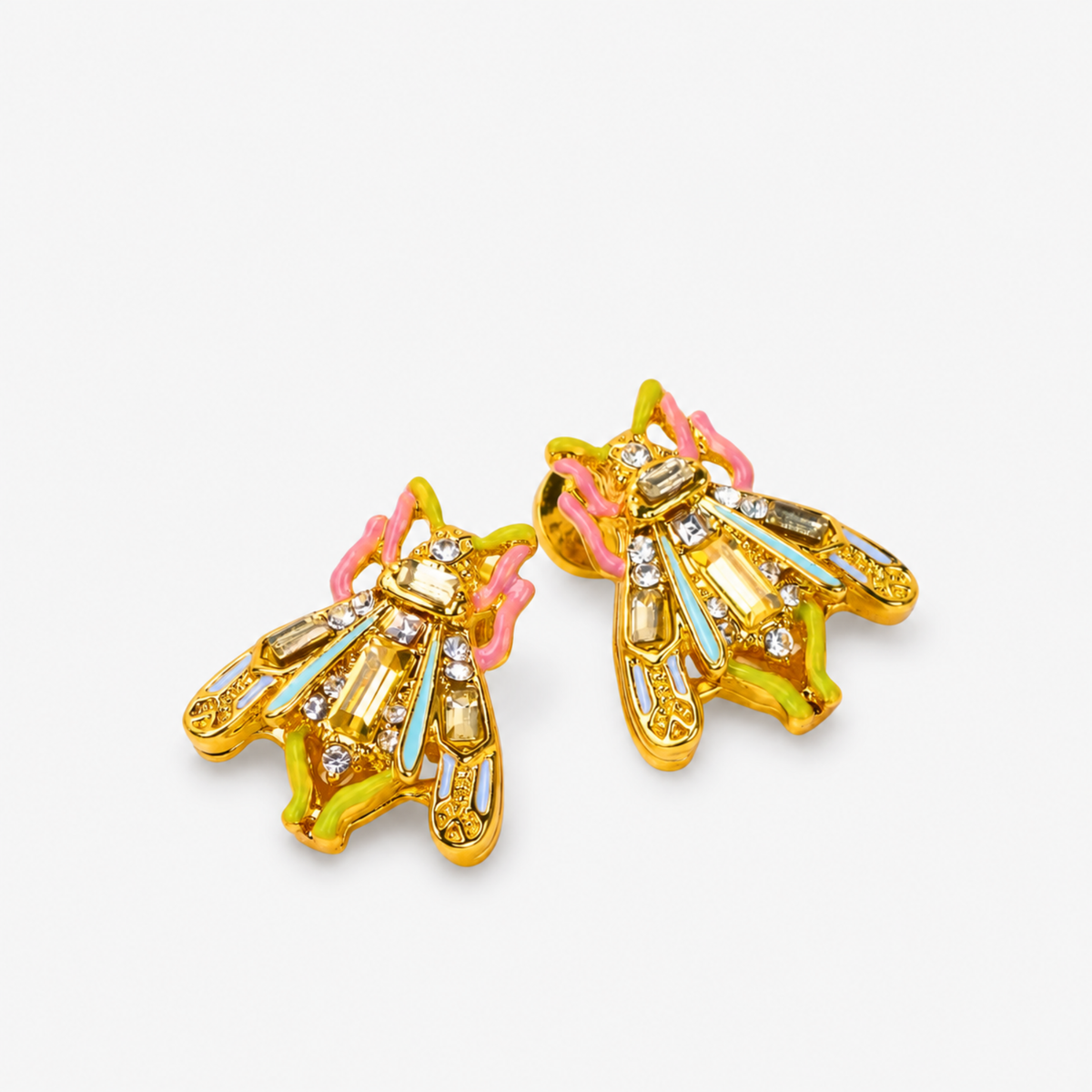 Miss Beasley Crystallique statement earrings shown on ear with sparkling wings and pastel accents.