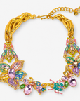 Sassy Jones Miss Beasley Necklace featuring pink crystal flowers, green stones and ornate jeweled beetle accents.