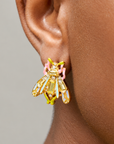 Close-up of Miss Beasley beetle earring featuring green, pink and clear crystals with Gold tone finish detailing.