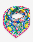 Mykonos Painted Floral Tapestry Scarf displayed flat with yellow lemons, blue pottery, pink flowers and a contrasting polka dot border.