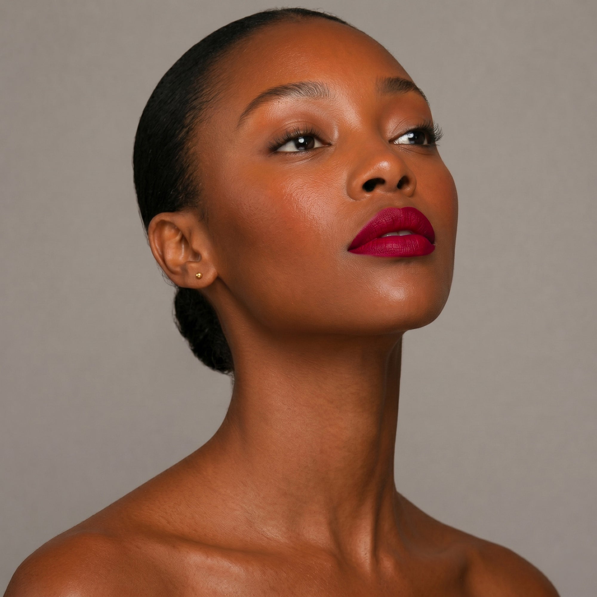 Bold red lipstick in gold tube with vibrant red swatch for a powerful statement lip look.