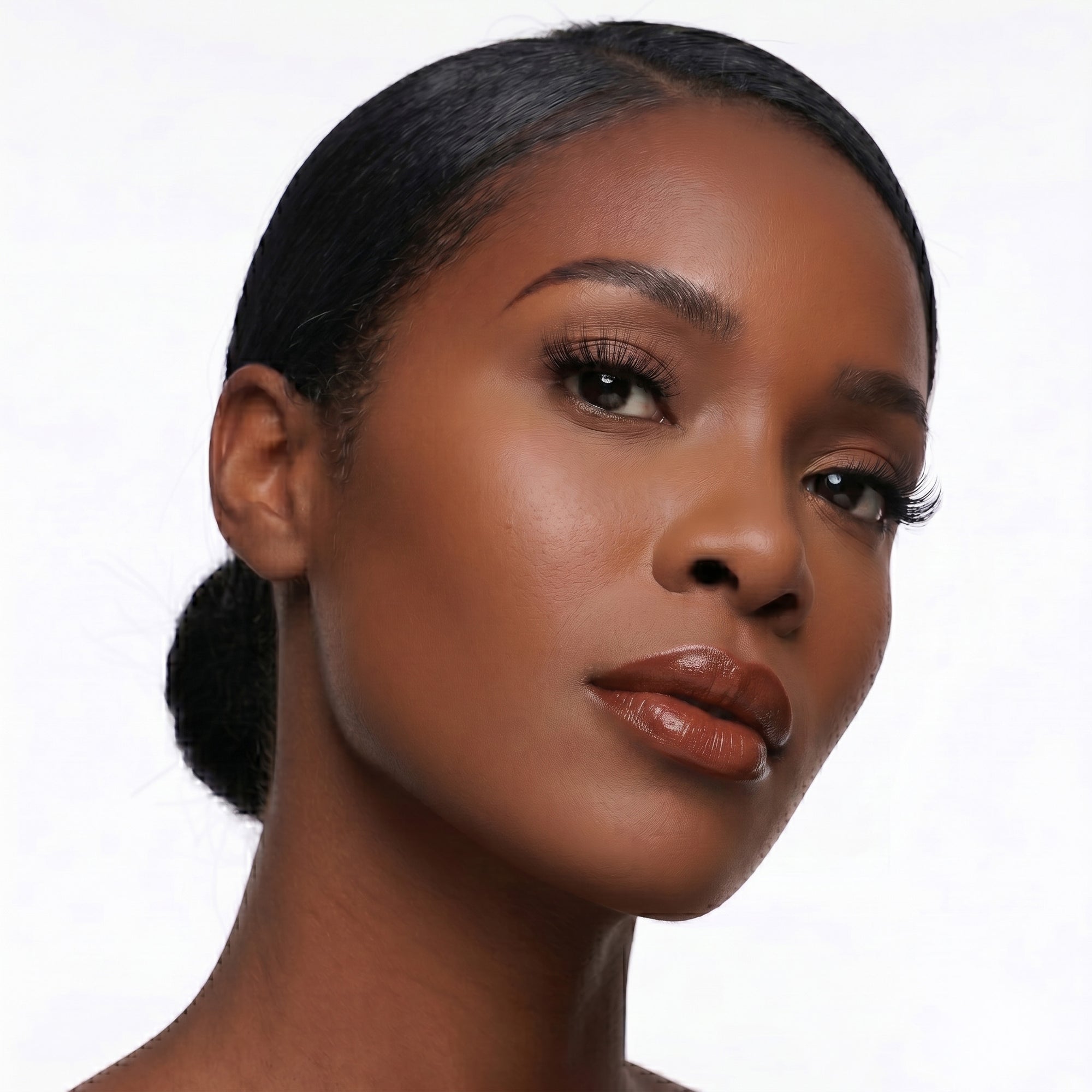 Rich brown nude lipstick in gold tube with deep neutral swatch for an elevated everyday glam look.