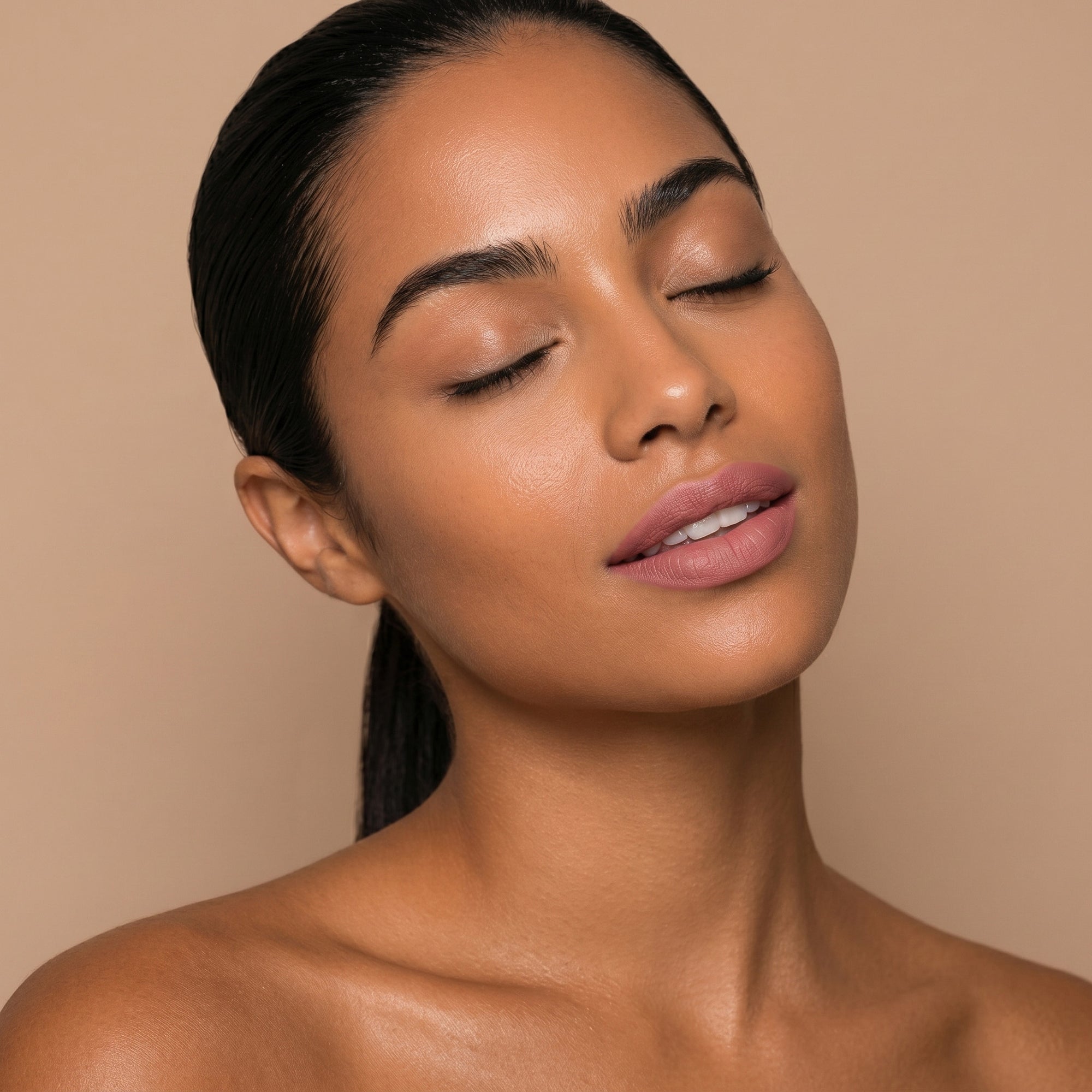 Soft nude pink lipstick in gold tube with natural rosy swatch for an everyday polished lip look.
