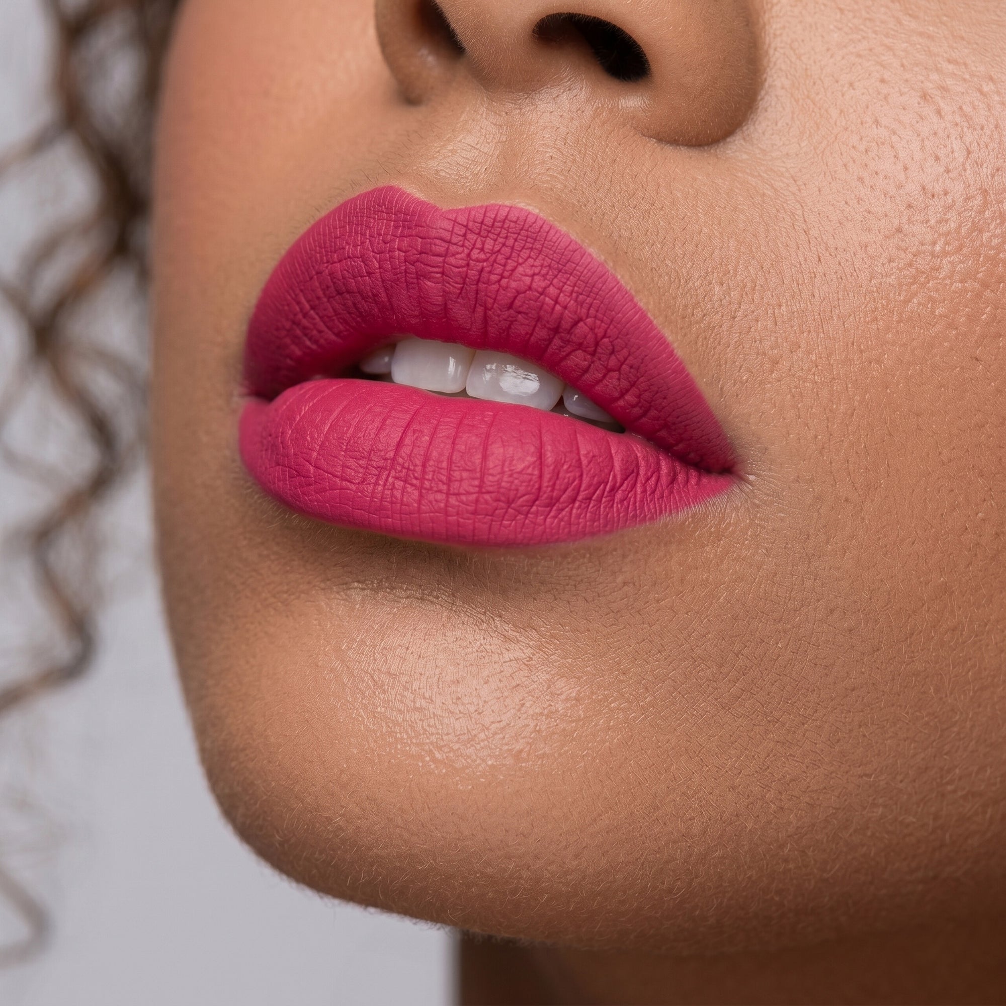 Bright pink lipstick in gold tube with rosy pink swatch for a fresh, playful lip look. best pink lipstick