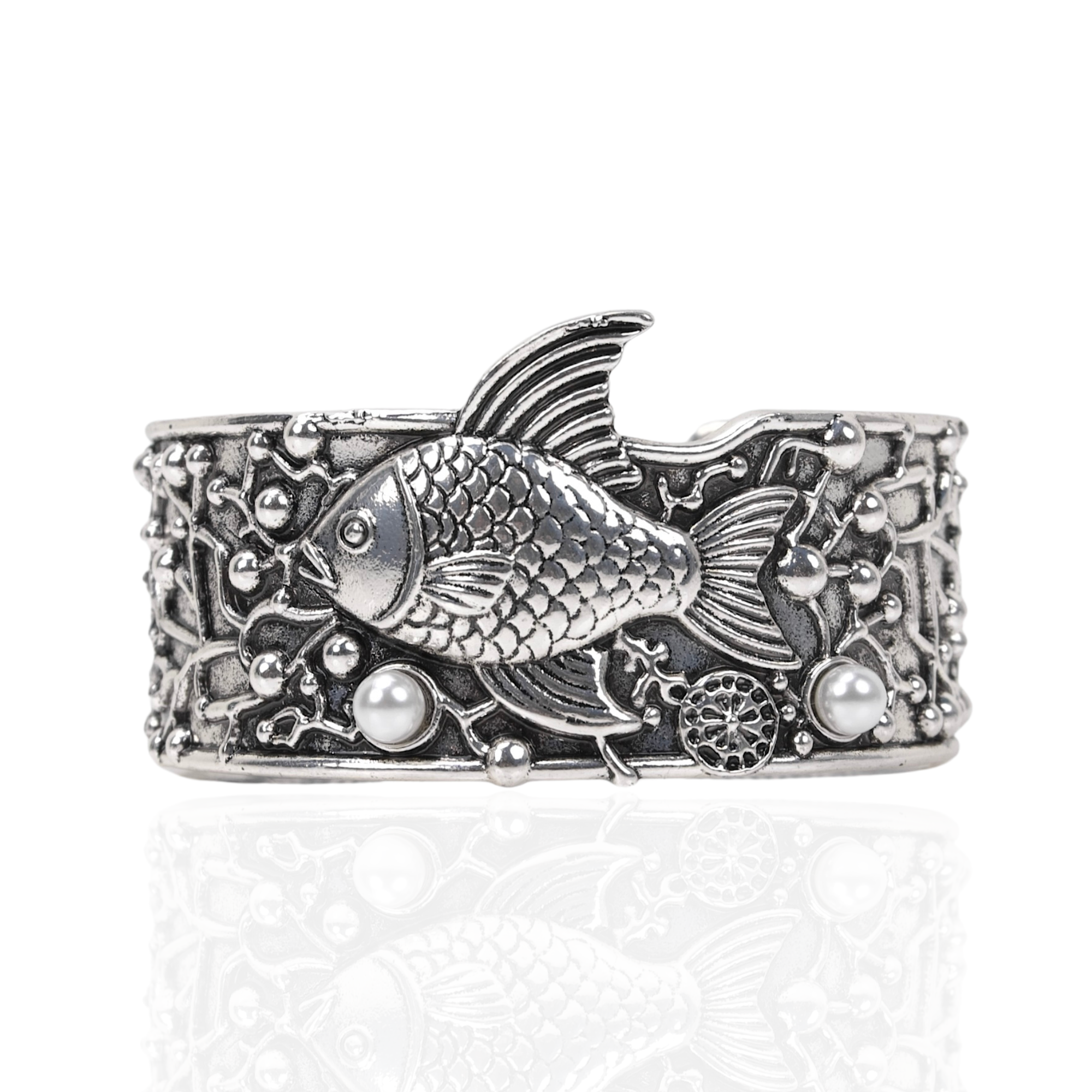 Antiqued silver open cuff bracelet featuring a sculpted fish, coral inspired textures, luminous pearl accents, and intricate ocean detailing.