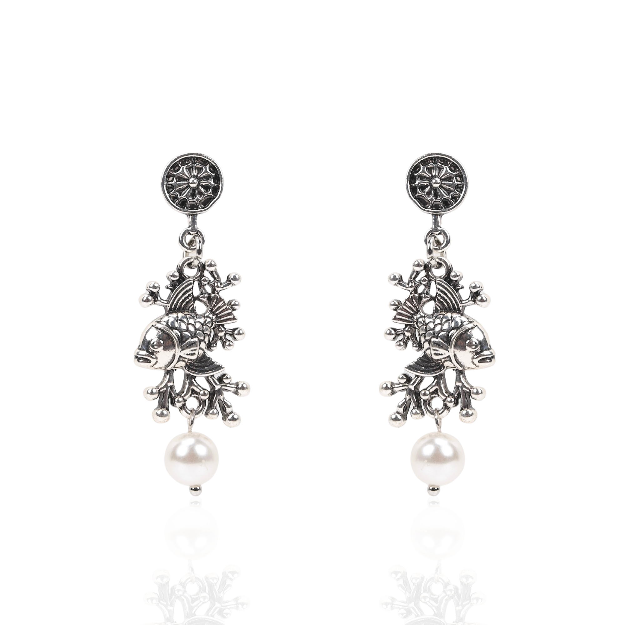 Antiqued silver fish dangle earrings featuring coral inspired detailing, luminous pearl drops, and sculptural ocean inspired elements.