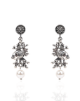 Antiqued silver fish dangle earrings featuring coral inspired detailing, luminous pearl drops, and sculptural ocean inspired elements.