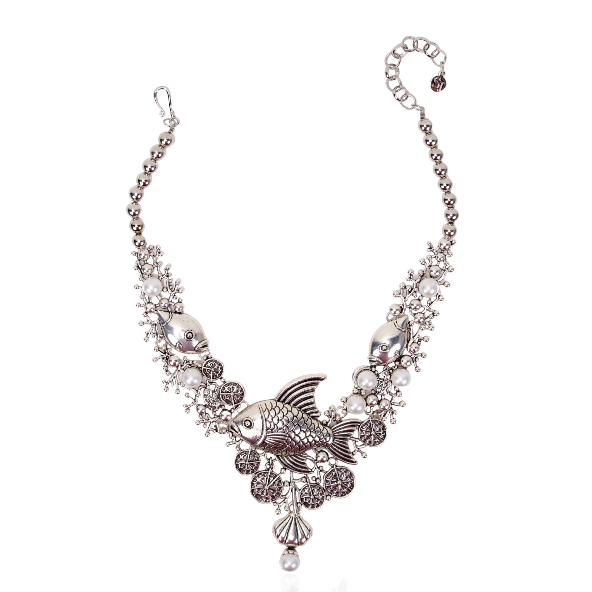 Antiqued silver statement necklace featuring sculpted fish, coral inspired branches, luminous pearl accents, shell details, and intricate ocean textures.