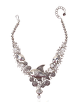 Antiqued silver statement necklace featuring sculpted fish, coral inspired branches, luminous pearl accents, shell details, and intricate ocean textures.