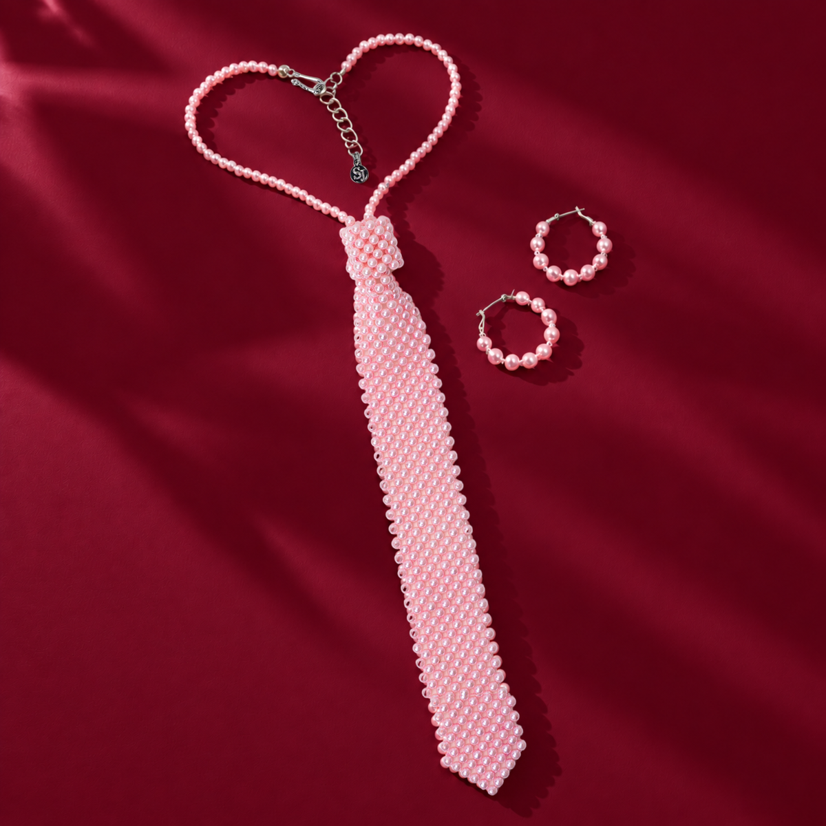 Pretty in Pink Pearls Duo featuring a pink pearl necktie necklace and coordinating pearl hoop earrings.