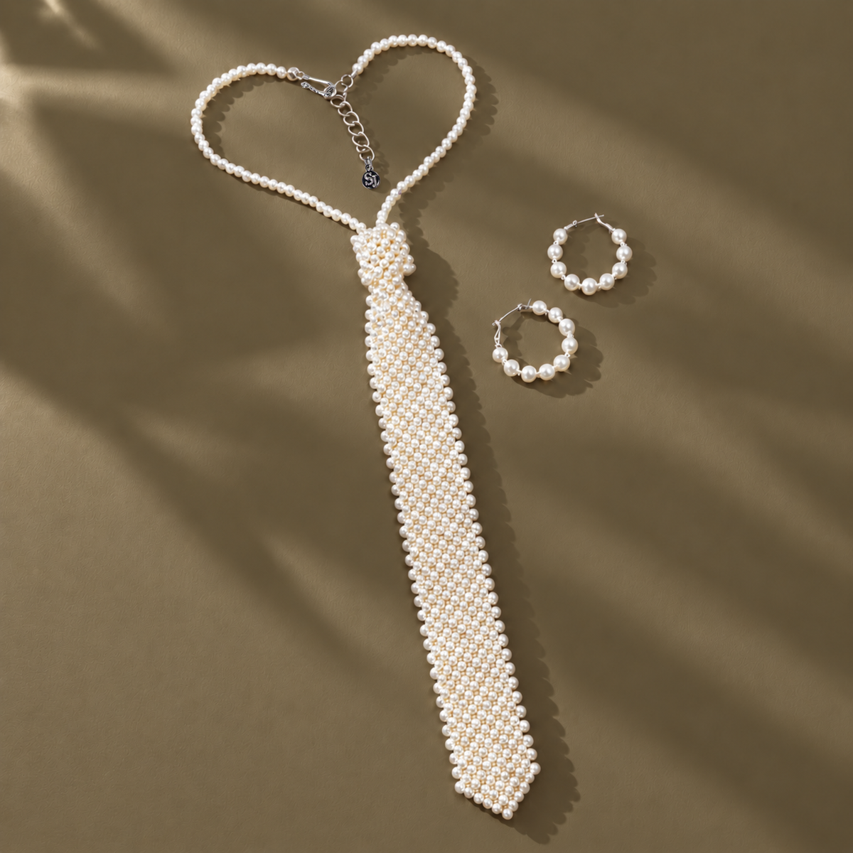 Pretty in White Pearls Duo featuring a white pearl necktie necklace and coordinating pearl hoop earrings.