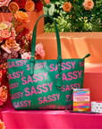 Pretty In The City promotional bundle featuring the Pink & Green Sassy City Tote, Maverick Lip Liner, Off Black Sculpt & Serve Brow Pencil, Confidence Card Stack, and Roxie Radiance Cuff by Sassy Jones.
