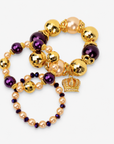 Close-up of Reign bracelet stack with oversized beads, crystal accents and jeweled gold crown charm. 