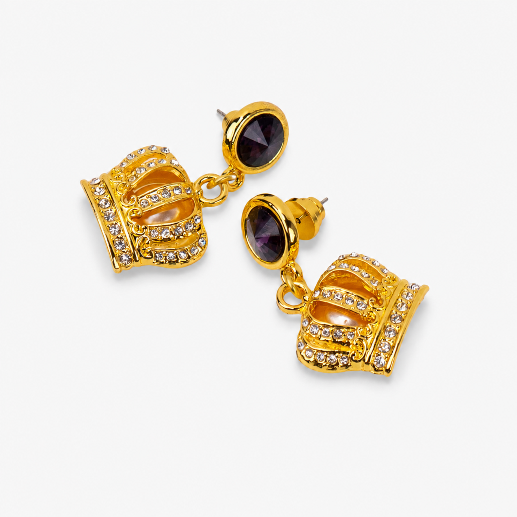 Gold crown statement earrings with rich purple faceted tops and crystal embellished detailing.   Sassy Jones Reign Pavé Crown Earrings featuring purple accents, champagne centers and ornate gold detailing.