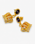 Gold crown statement earrings with rich purple faceted tops and crystal embellished detailing.   Sassy Jones Reign Pavé Crown Earrings featuring purple accents, champagne centers and ornate gold detailing.