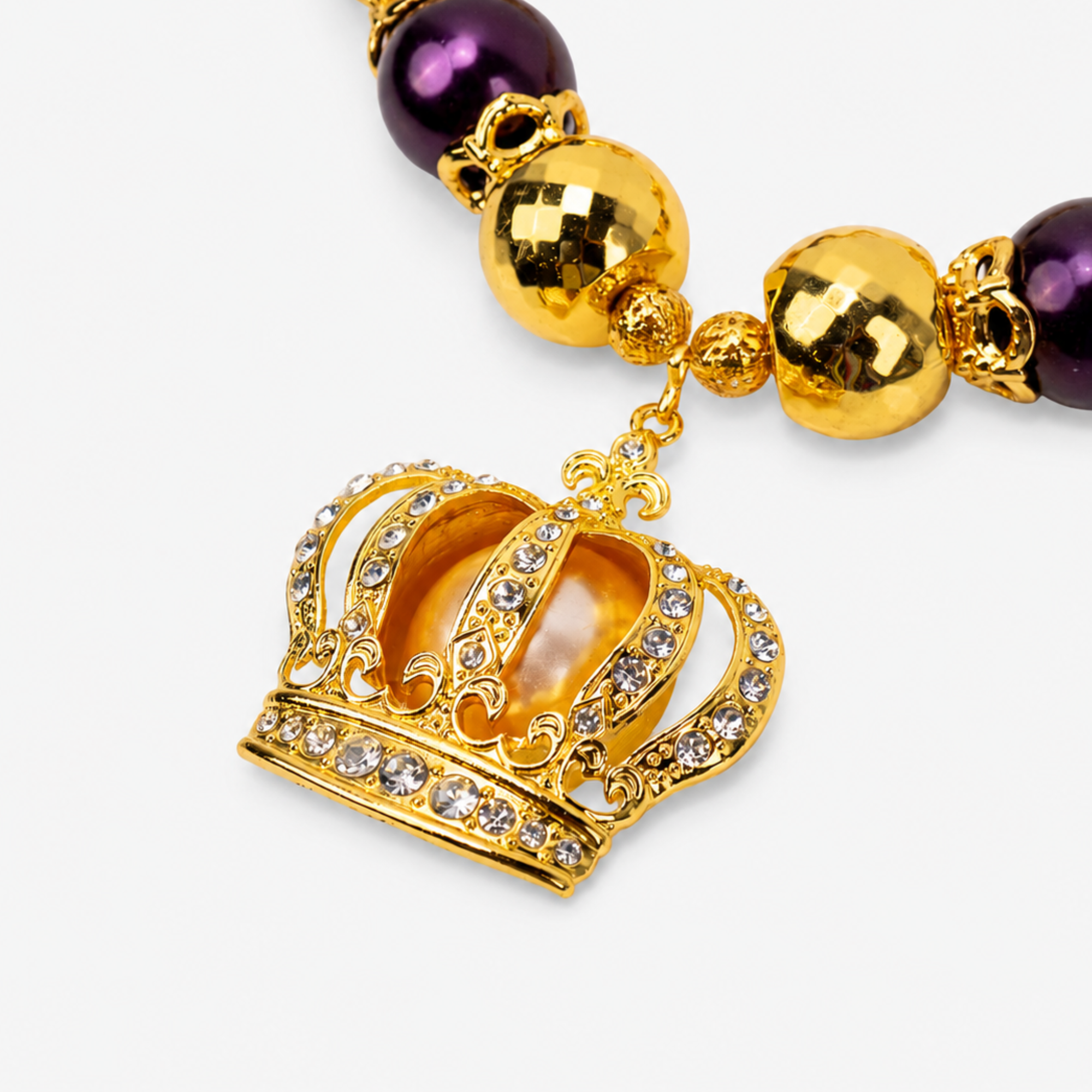 Gold crown statement necklace featuring champagne pearls, deep purple beads and sparkling pavé details.