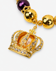 Gold crown statement necklace featuring champagne pearls, deep purple beads and sparkling pavé details.