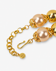 Sassy Jones Reign necklace with champagne pearl beads, metallic gold beads and crystal embellished crown pendant.