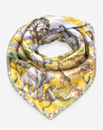 Samba Serengeti Oversized Square Scarf displayed flat with colorful wildlife illustrations and a soft green botanical border.