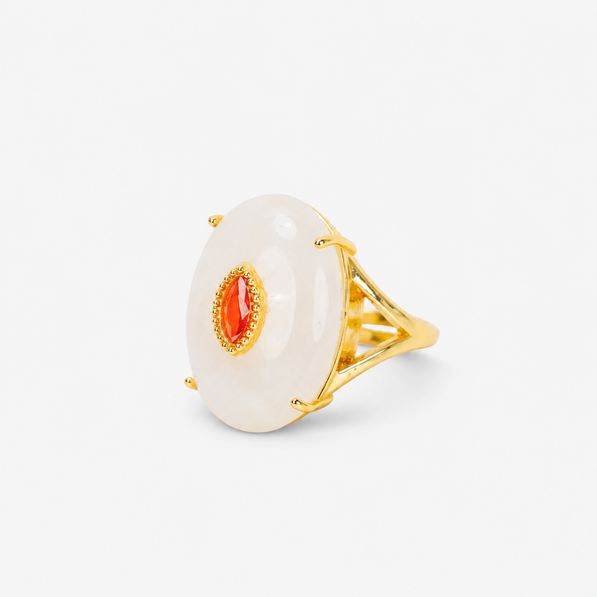 Ivory statement ring featuring a smooth pale stone, amber colored center detail and Gold tone finish.