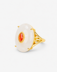 Ivory statement ring featuring a smooth pale stone, amber colored center detail and Gold tone finish.